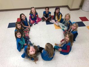 Daisy Girl Scouts sitting in a circle.